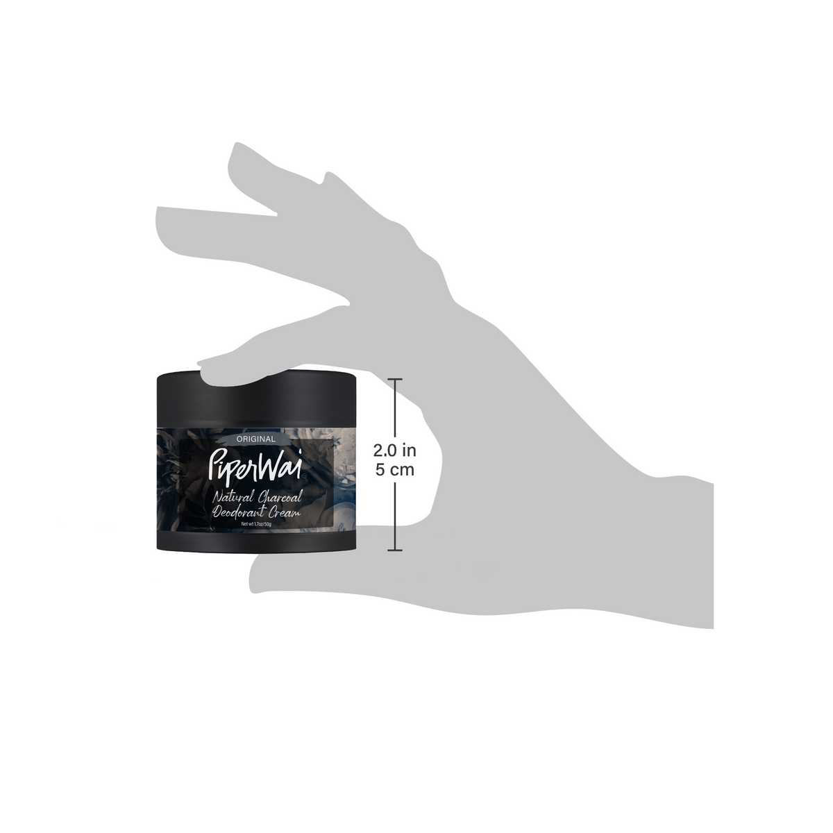 Hand holding a jar of PiperWai product with a measurement label on a white background