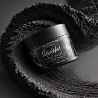 A black jar of PiperWai Original Natural Charcoal Deodorant Cream, styled on a dark textured surface with a matching dark gray towel.

